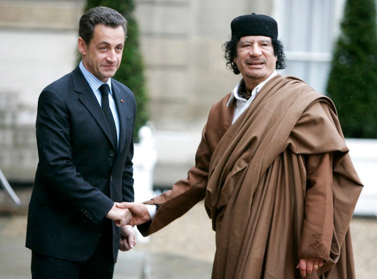 French President Nicolas Sarkozy greets Libyan leader Col. Moammar Gadhafi upon his arrival at the Elysee Palace, in Paris, in December 2007.