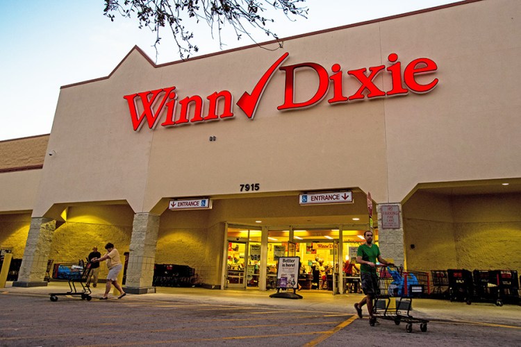 Shoppers exit a Winn-Dixie Store supermarket in Palm Beach, Florida, recently. Southeastern, which owns more than 600 Winn-Dixie, Harvey's and BI-LO stores across seven states in the Southeast, announced a refinancing agreement on March 15 and says it will file for bankruptcy by April.