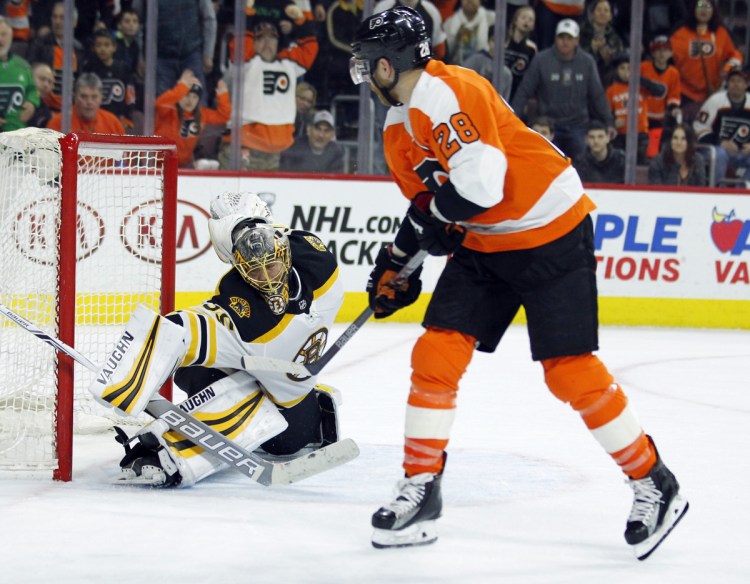 Philadelphia's Claude Giroux, right, beats Bruins goalie Anton Khudobin for the winning goal in overtime Sunday in Philadelphia. The Flyers won 4-3.