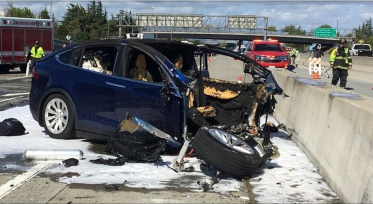 Emergency personnel work at the scene where a Tesla electric SUV crashed into a barrier on Highway 101 in Mountain View, Calif., on March 23, killing the driver.