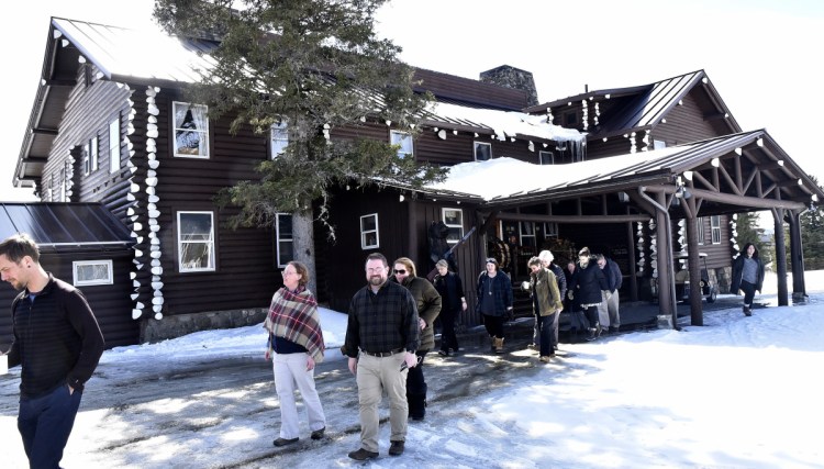 Unity College administrators and staff leave the Sky Lodge in Moose River last week to tour the property that was given to the college by John and Elaine Couri.