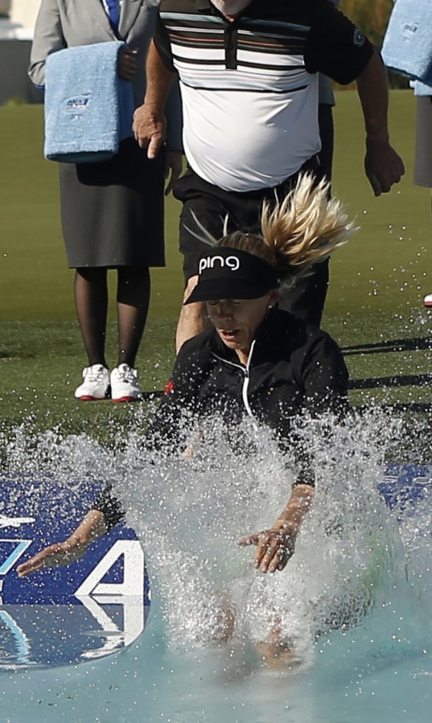 Pernilla Lindberg takes the traditional winner's jump into Poppie's Pond after her victory Monday in the ANA Inspiration.