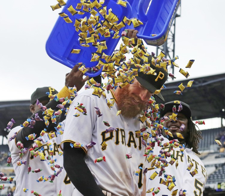 Colin Moran gets a bubble gum shower from Pittsburgh teammates Gregory Polanco, left, and Josh Bell following the Pirates' 5-4 win Monday against the Twins.