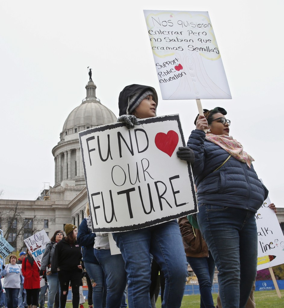Teachers picket around the Oklahoma State Capitol in Oklahoma City, Monday, April 2, 2018, as teachers rally against low school funding. (AP Photo/Sue Ogrocki)
