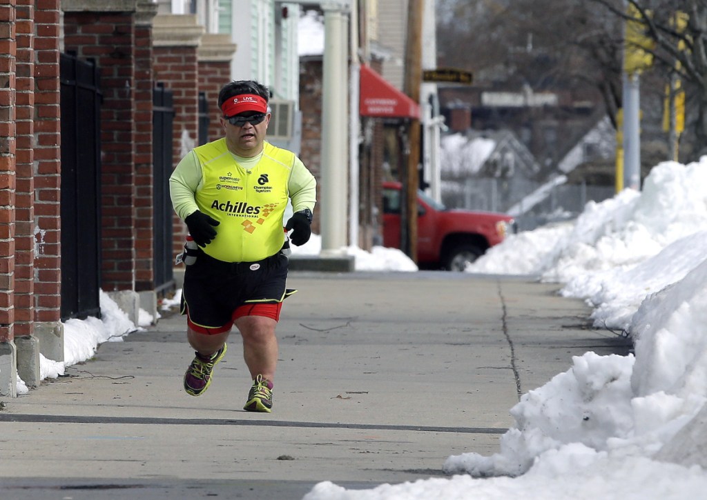 Runner John Young makes his way along a training route in Salem, Mass. in March. 