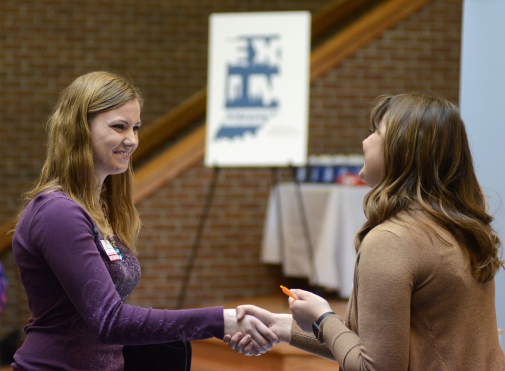 Indiana Wesleyan University senior Courtney Kingma, left, thanks Jennie Hehe, a hiring manager for Tangram, after an interview at a job fair in Marion, Ind., last month.
