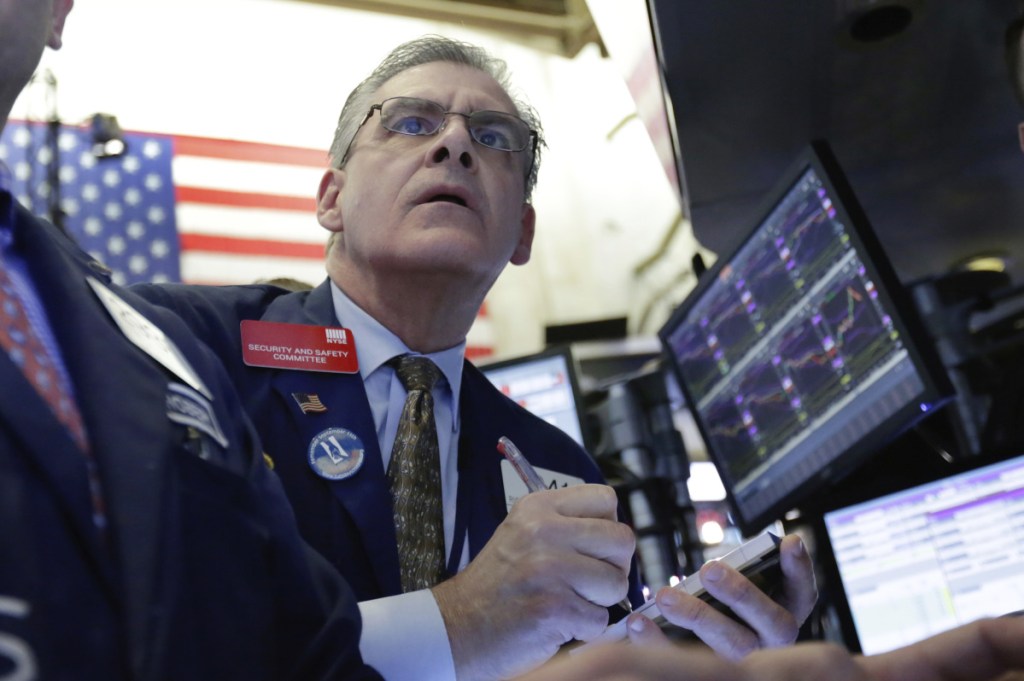 Trader Richard Deviccaro works the floor of the New York Stock Exchange. With Friday's 572-point drop, the Dow is down 10 percent from late January's record high. The S&P 500, Nasdaq and Russell 2000 indexes also lost ground Friday.