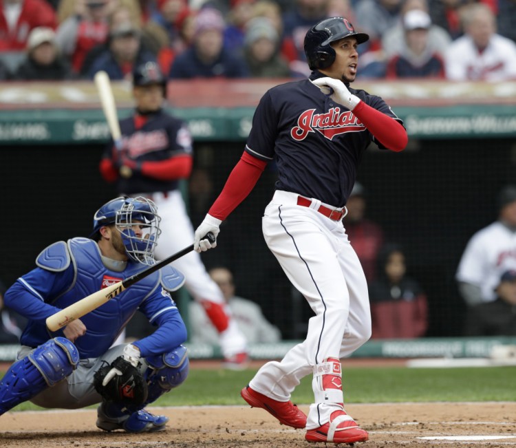 Michael Brantley of the Indians watches his two-run single in the first inning Friday against the Royals. The Indians won their home opener, 3-2.