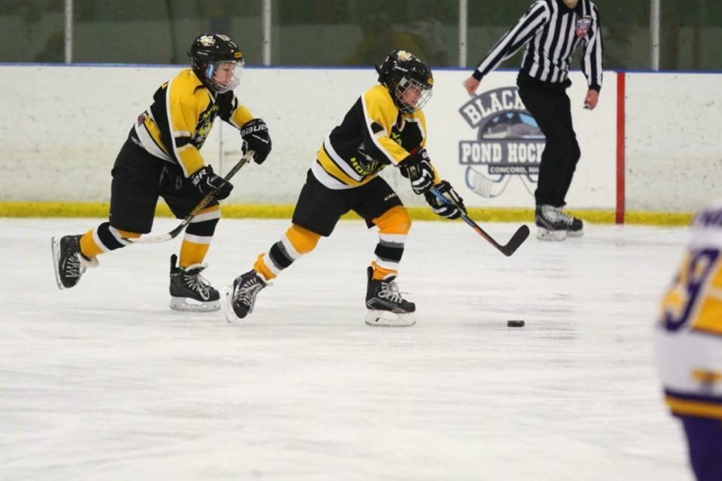 Bret Lambert, right, and Cooper Tardiff skate in a CMYHA squirt game this winter.