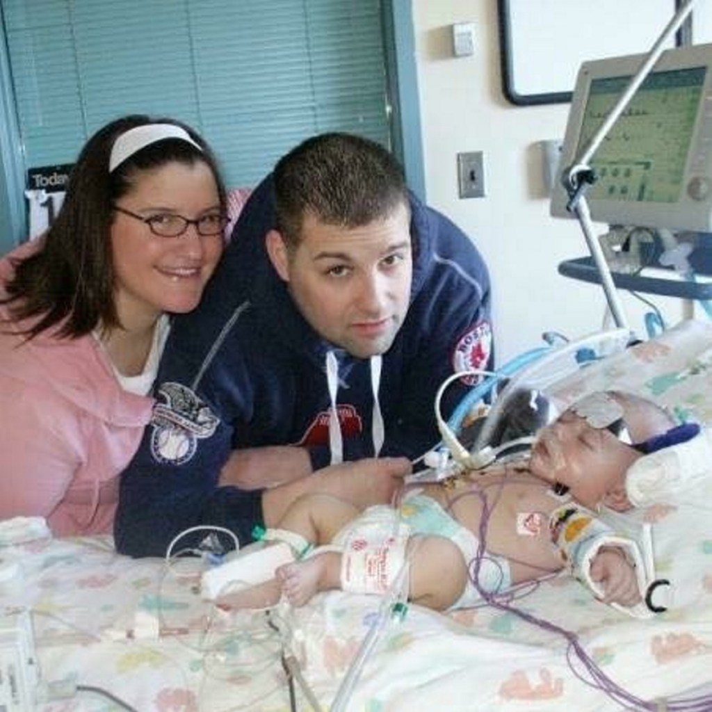 Becky Lambert, left, and Andy Lambert with their son Bret after he was born in 2007 with four life-threatening heart conditions. Now 10 years old, Bret has a pacemaker and is allowed to play non-checking hockey at the youth level.