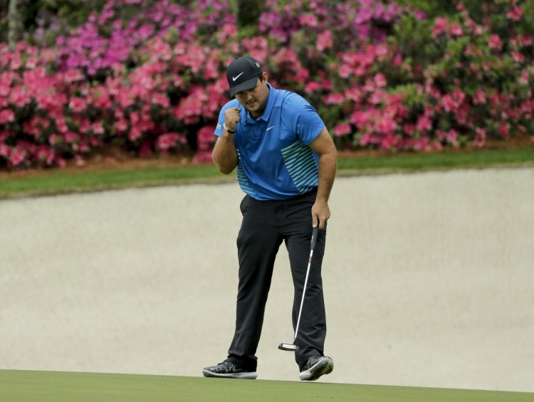 Patrick Reed celebrates his eagle on the 13th hole during the third round of the Masters on Saturday in Augusta, Ga. Reed is 14-under par and leads the tournament by three shots.