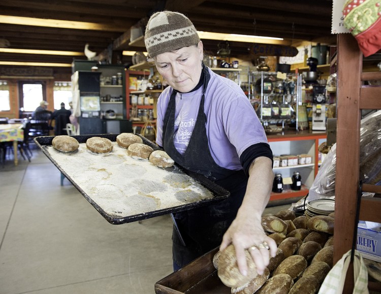 Gloria Varney puts out fresh-baked dinner rolls at Nezinscot Farm in Turner. Varney offers what she calls a "Full Diet CSA," a program in which members buy shares that are treated as credits that customers can spend on anything, including organic vegetables, eggs, baked goods and meals at the farm cafe. 