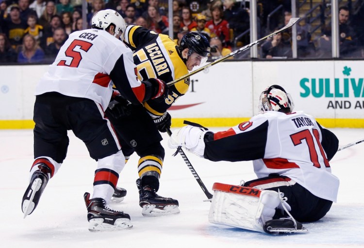Boston's Noel Acciari tries to get a shot off against Ottawa's Daniel Taylor as Cody Ceci defends during the second period of the Bruins' 5-2 win Saturday in Boston.