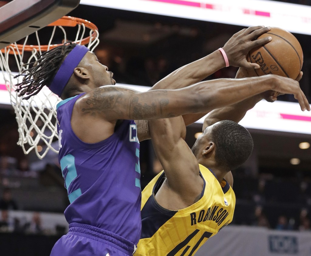 Glenn Robinson III of the Indiana Pacers, right, is fouled by Julyan Stone of the Charlotte Hornets during Indiana's 123-117 victory.