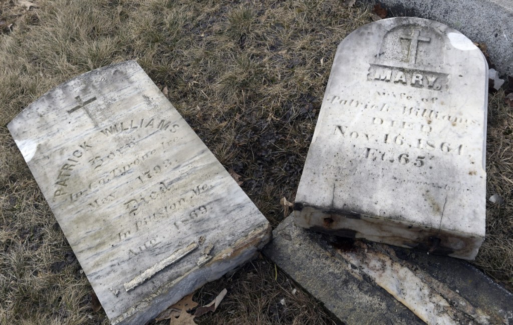 These headstones at St. Denis Cemetery in Whitefield. seen Tuesday, are among many stones of Irish Catholic immigrants who arrived in the community in the early 19th century. They were damaged during a recent car crash that remains under investigation.