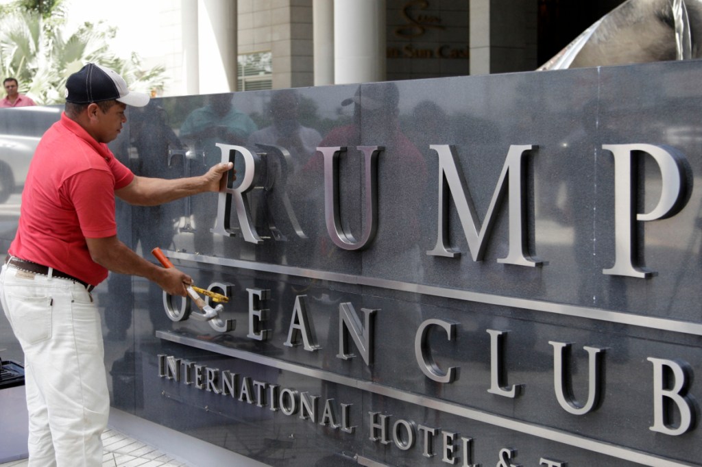 A worker removes the word Trump from a marquee outside the Trump Ocean Club International Hotel and Tower in Panama City, Panama, on March 5. The Britton & Iglesias firm, which has represented the Trump Organization in its fight to continue running the hotel, addressed a letter dated March 22 to President Juan Carlos Varela that appealed for help days before an emergency arbitrator declined to reinstate the Trump management team to the luxury waterfront hotel.