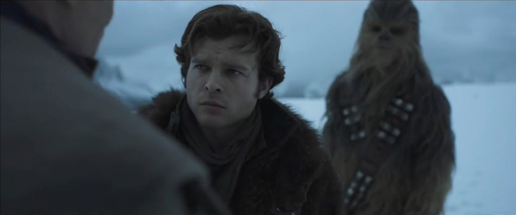 Solo (Alden Ehrenreich) listens to the mission in "Solo: A Star Wars Story."