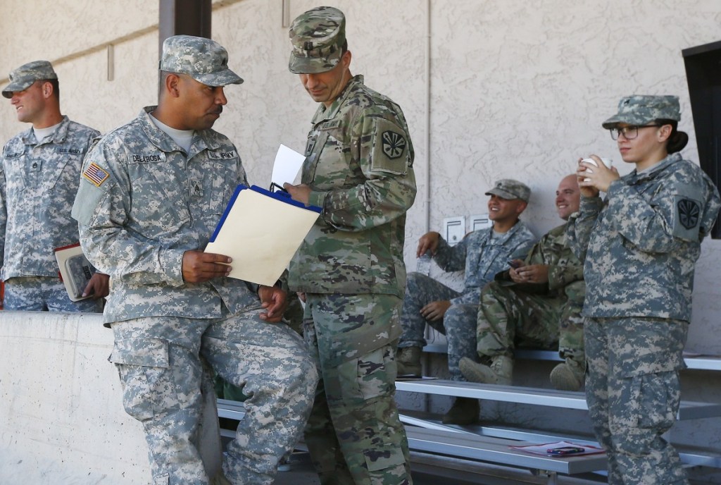 Arizona National Guard soldiers receive their reporting paperwork prior to deployment to the Mexico border at the Papago Park Military Reservation, Monday in Phoenix.