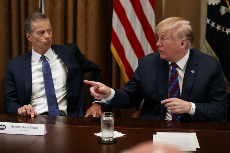 Sen. John Thune, R-S.D., listens as President Trump speaks during a meeting with governors and lawmakers in the Cabinet Room of the White House on Thursday in Washington. Trump suggested exploring the possibility of rejoining the Trans-Pacific Partnership.