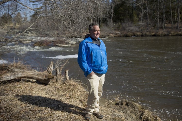 Alan Stearns stands next to the Royal River in Yarmouth.