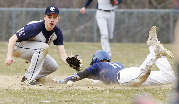 York's Tim McDonald slides safely into second while Yarmouth's Aidan Hickey awaits the throw during the season-opening game for both teams Thursday in Yarmouth. The Clippers rallied to a 4-3 win.