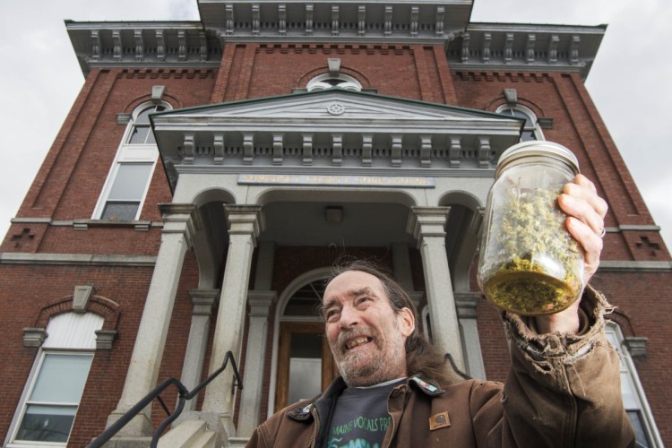 Donny Christen holds an ounce of pot Friday at the Somerset County Courthouse. "We want people to be free and treat this just like any other vegetable or crop that's grown," he said.