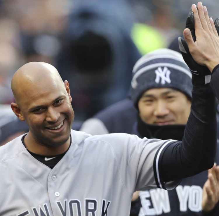 Aaron Hicks is welcomed back to the dugout Friday night after hitting an inside-the-park home run for the New York Yankees in an 8-6 victory at Detroit.