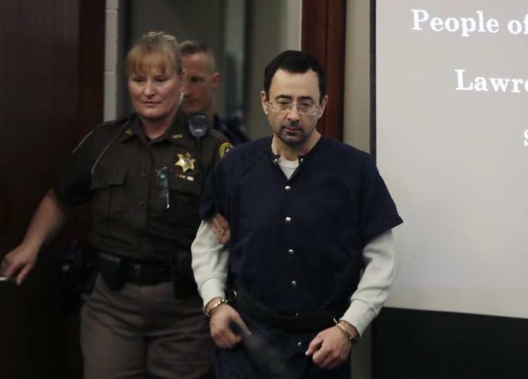 Dr. Larry Nassar is escorted into court during the seventh day of his sentencing hearing on Jan. 24 in Lansing, Mich. Nassar was the USA Gymnastics national team doctor and an osteopathic physician at Michigan State University who was accused of molesting at least 250 girls and young women. After three trials, Nassar was sentenced to hundreds of years in prison.