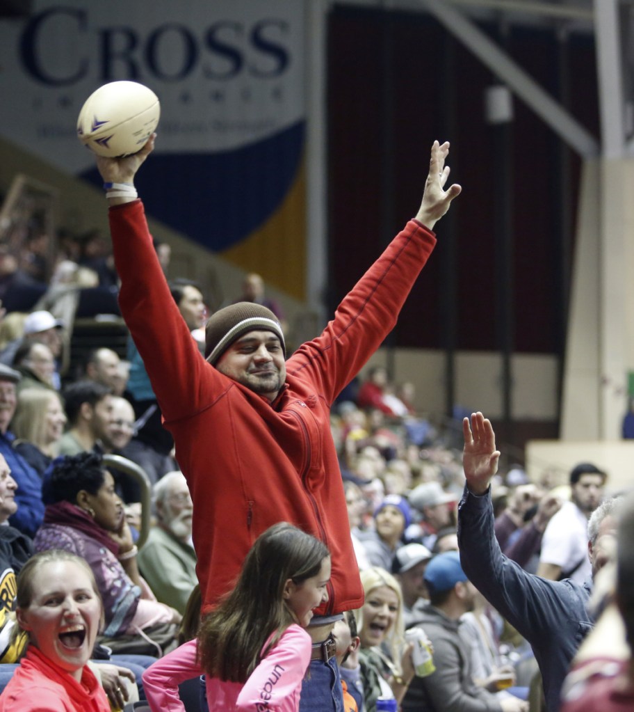Angelo Salvaggio of Portland celebrates hauling in a game ball that went into the stands during the Mammoths' game against Carolina. Fans are allowed to keep balls that enter the stands.