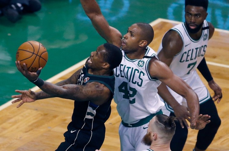 Milwaukee's Eric Bledsoe goes up to shoot in front of Boston's Al Horford during Game 1 of their first round NBA playoff series on Sunday in Boston.