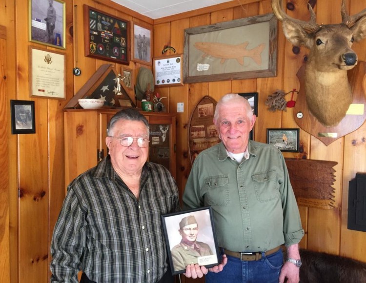 Standish Legion Post Commander Don Roy, left, and Post Historian Hal Ware hold a photo of Pfc. Stuart W. Hooper, believed to be the first Standish resident to die in World War II.