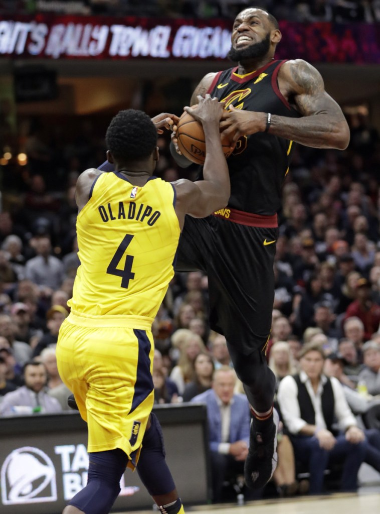 LeBron James of the Cleveland Cavaliers attempts to drive against Victor Oladipo of the Indiana Pacers during the first half of the Pacers' 98-80 victory Sunday in Game 1 of their first-round series.