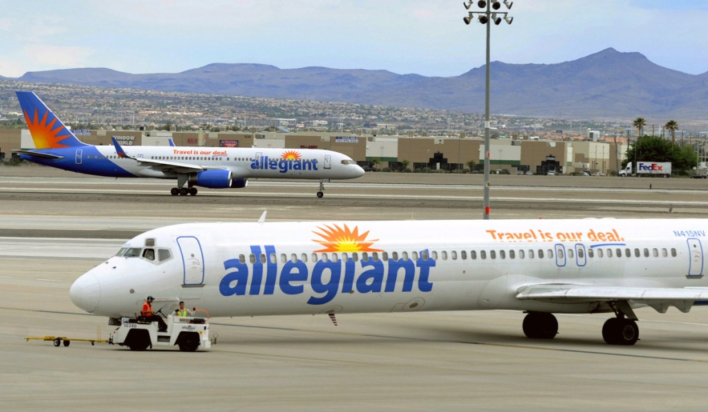 Two Allegiant Air jets taxi at McCarran International Airport in Las Vegas in 2013. The airline's shares continued to fall in the aftermath of a news report that raised safety questions.