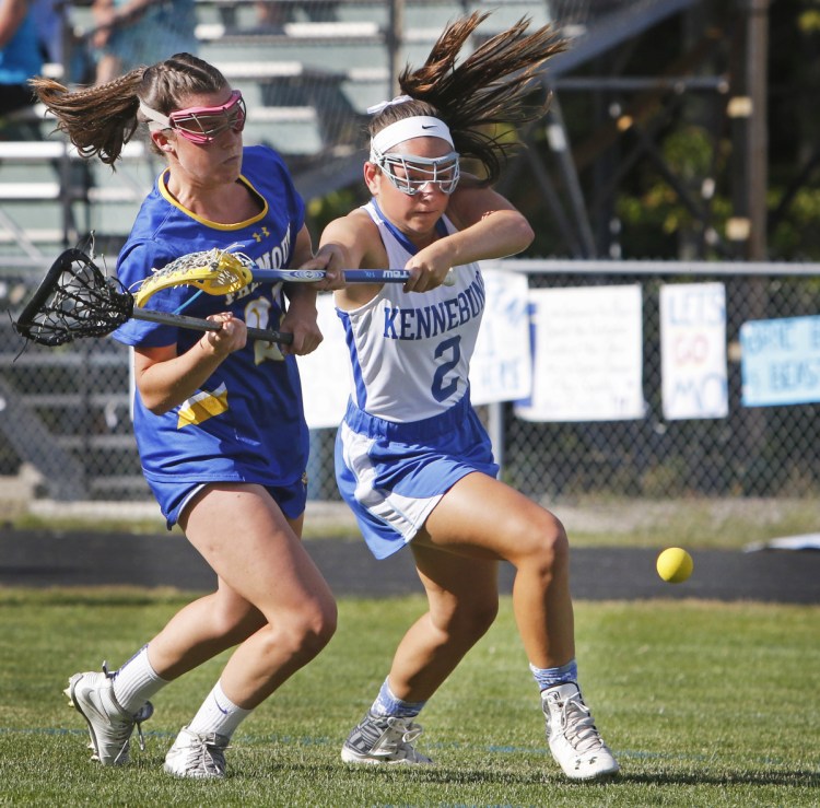 KENNEBUNK, ME - JUNE 15: Kennebunk #2 Hallie Schwartzman holds off Falmouth #21 Sydney Bell during second half action at Kennebunk in the Class B South girls lacrosse regional final. (Photo by Jill Brady/Staff Photographer)