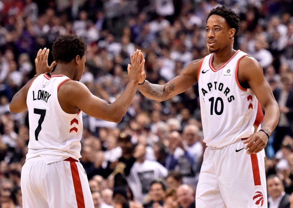 Toronto's Kyle Lowry, left, and teammate DeMar DeRozan celebrate a basket against the Washington Wizards during Tuesday's first-round playoff game in Toronto. The Raptors won to take a 2-0 series lead.