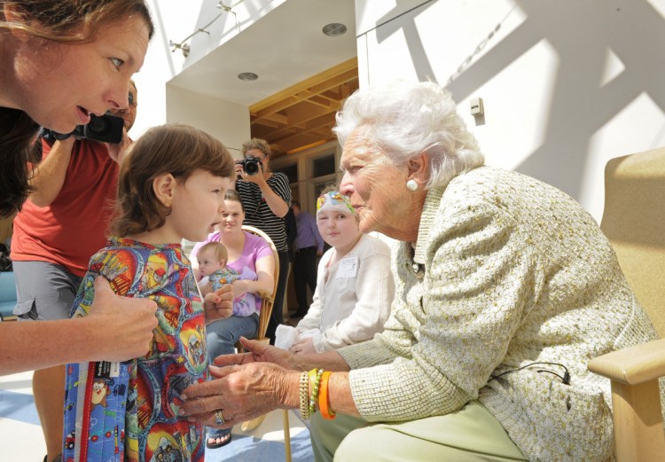 Barbara Bush visits and reads a story to patients at the Barbara Bush Children's Hospital at Maine Medical Center in Portland in 2013. The hospital is the best-known testament to the generosity of the former first lady toward the state where she spent 74 summers.