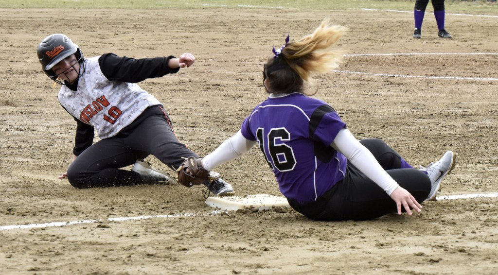 Winslow's Cassie Demers slides safe into third base as Waterville's McKayla Nelson attempts the tag Wednesday in Winslow.