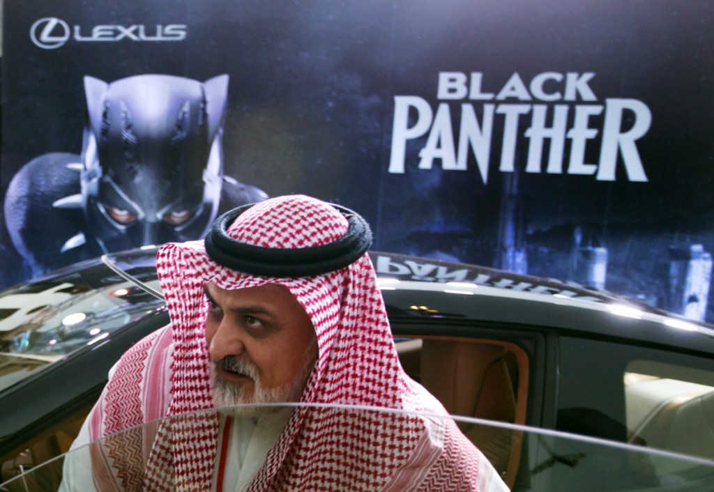 A visitor checks out a Lexus car, similar to a one used in the "Black Panther" film, on display Wednesday outside an invitation-only screening, at the King Abdullah Financial District Theater, in Riyadh, Saudi Arabia.