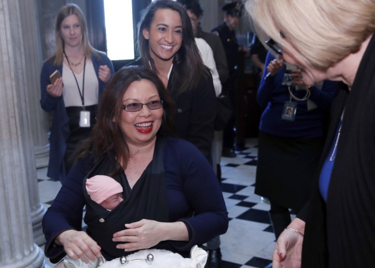 Sen. Tammy Duckworth, D-Ill., heads for the Senate floor with her baby, Maile Pearl Bowlsbey, on Thursday, the first time in history that an infant was allowed.