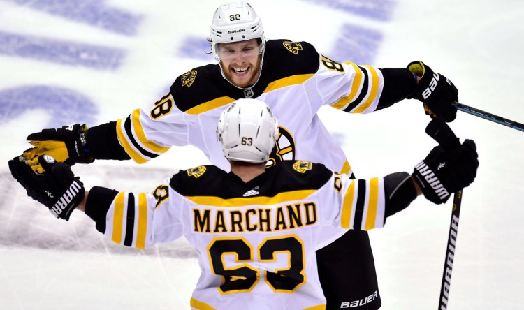 Brad Marchand celebrates with teammate David Pastrnak after scoring a goal in the second period against the Toronto Maple Leafs on Thursday in Toronto in Game 4 of their first-round playoff series. Boston won 3-1 and has a 3-1 lead in the series.