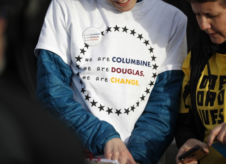 A student wears a shirt printed with a message during the kickoff event for the Vote For Our Lives movement to register voters Thursday at Clement Park in Littleton, Colo. The event was held on the eve of the 19th anniversary of the shootings at Columbine High School, which is located on the east end of the park southwest of Denver.