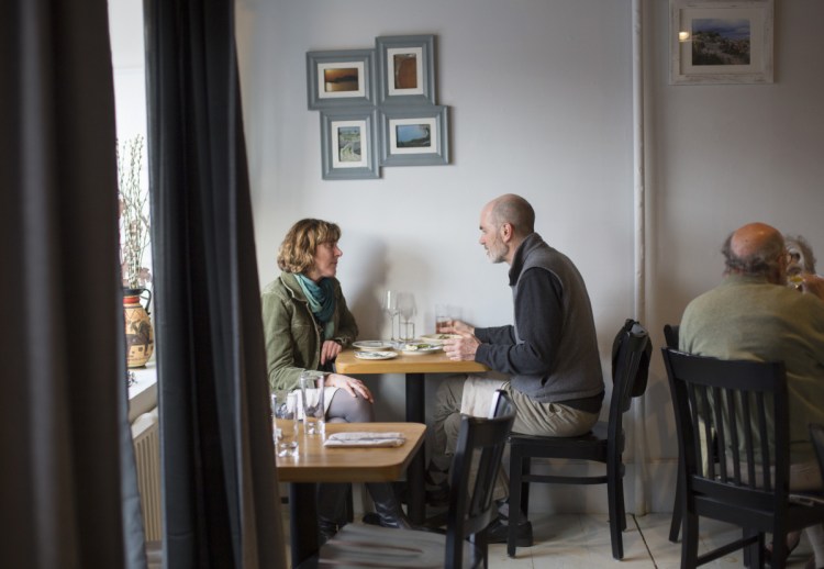Amanda Myers of Freeport and Erich Bohrmann of Yarmouth share a meal at Taverna Khione, which is in the space formerly occupied by Trattoria Athena, also operated by chef Marc Provencher.