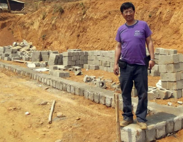 The Rev. John Sanqiang Cao breaks a ground on a school in Myanmar in 2014. He was sentenced in China last month for "organizing others to illegally cross the border."