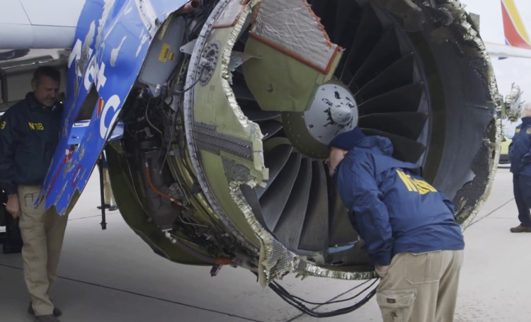 National Transportation Safety Board investigators examine damage to the engine of a Southwest Airlines plane that made an emergency landing at Philadelphia International Airport on Tuesday. Under a new FAA order, all CFM 56-7B engines that have gone through at least 30,000 takeoffs or landings must be inspected within 20 days.