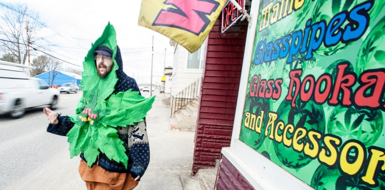 Devin Urquart of Lewiston, whose alias is "Blunt Man," dances in front of Legal Peaces on Lisbon Street in Lewiston on Friday morning. "It's 4/20, my favorite holiday and I'm just rocking out here to get some attention for the business," he said.