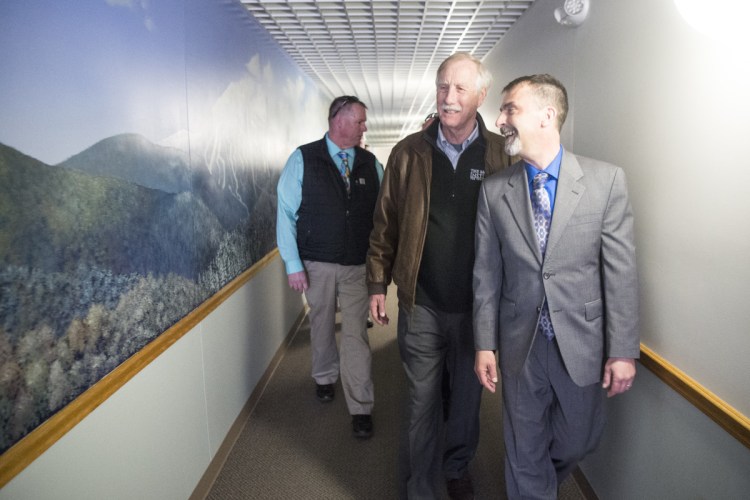 David Cyr, right, vice president of Skowhegan Savings Bank, and U.S. Sen. Angus King, I-Maine, center, head to to the bank's security room where internet traffic is monitored. King talked to IT professionals there about the high number of cyberattacks the bank blocks daily.