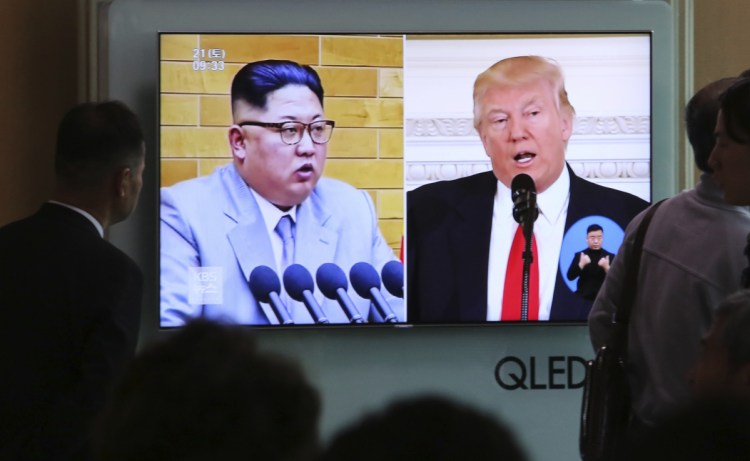 People watch a TV screen showing President Trump and North Korean leader Kim Jong Un during a news show at the Seoul Railway Station in Seoul, South Korea, on Saturday.