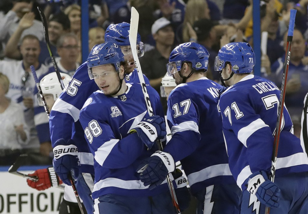 Tampa Bay Lightning defenseman Mikhail Sergachev (98) celebrates with teammates after his goal against the New Jersey Devils on Saturday.