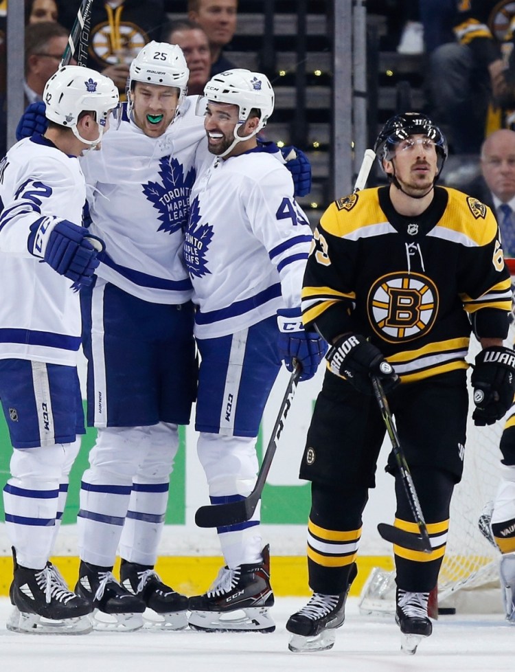 James van Riemsdyk, second from left, celebrates a goal with teammates Tyler Bozak, left, and Nazem Kadri during Toronto's 4-3 win Saturday night against the Bruins.