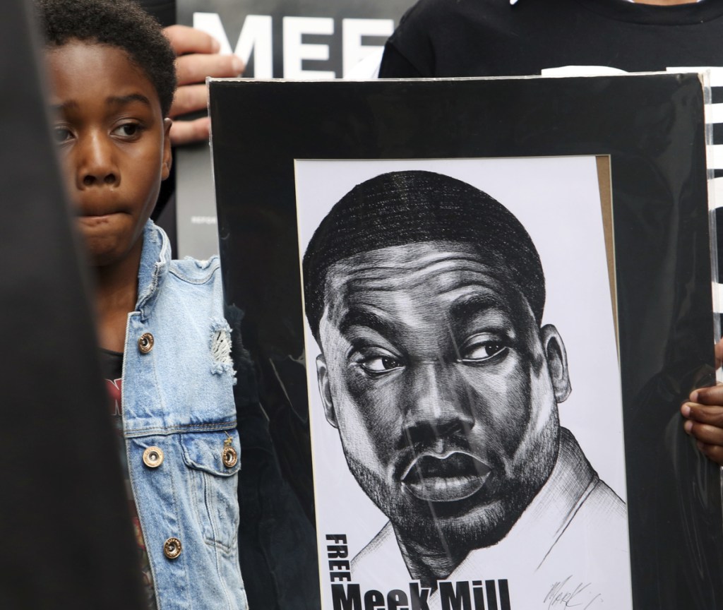 Papi Mills, the son of rapper Meek Mills, holds a poster last week during a protest calling for his father's release from prison while he appeals decade-old gun and drug convictions.